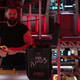 Amos Burton (Wes Chatham) stands behind a tool box marked "Amos" aboard the Rocinante on The Expanse.